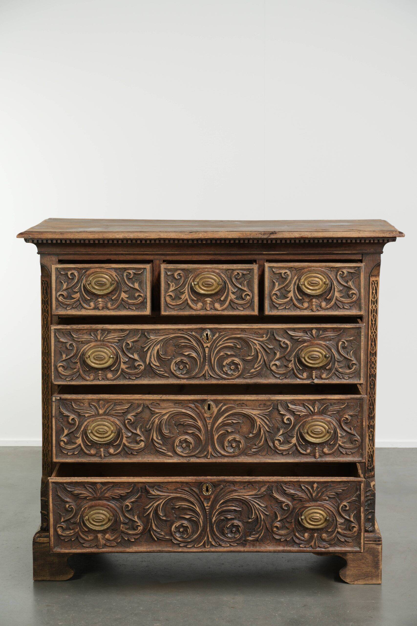Richly carved English oak chest of drawers from the 18th century