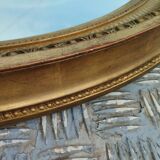 Antique oval mirror in gilded stucco with gold leaf, 19th century