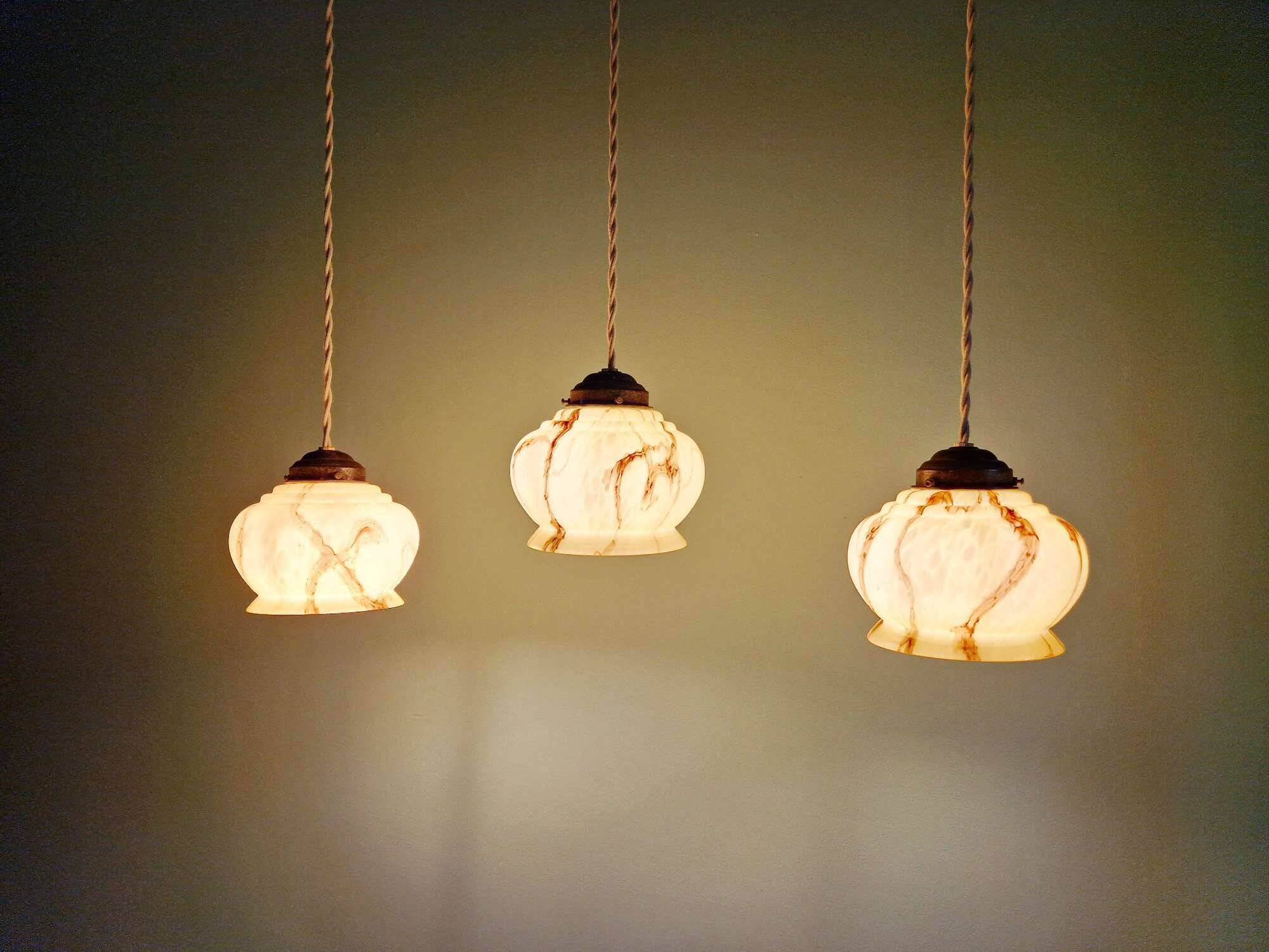 Trio of Art Deco marbled opaline pendant lights, 1920-30