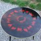 Vintage coffee table with glass top and tripod legs in blackened wood from the 1960s.