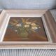 An old painting in oil on canvas depicting a bouquet of flowers.