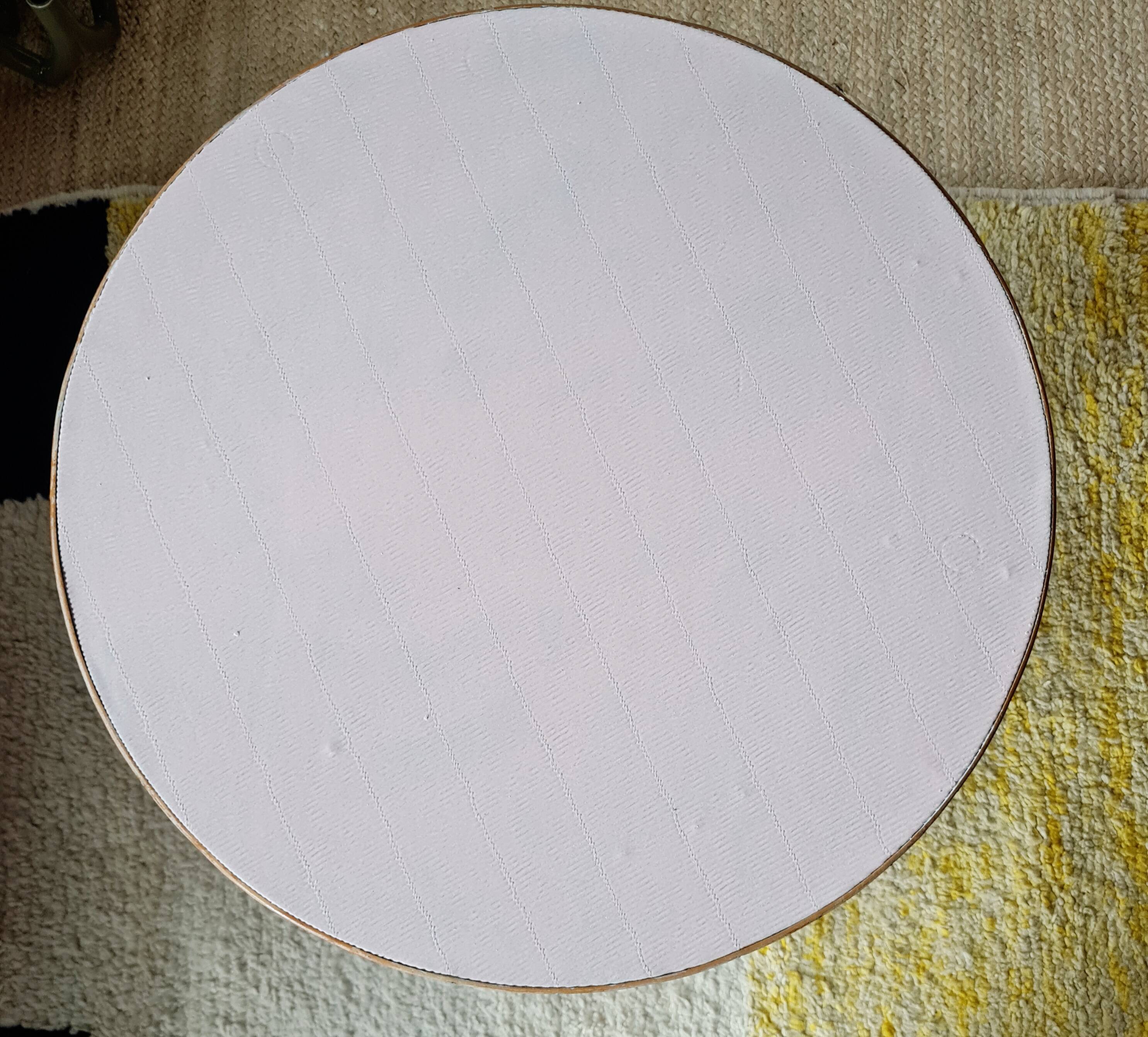 Round soft pink rattan table