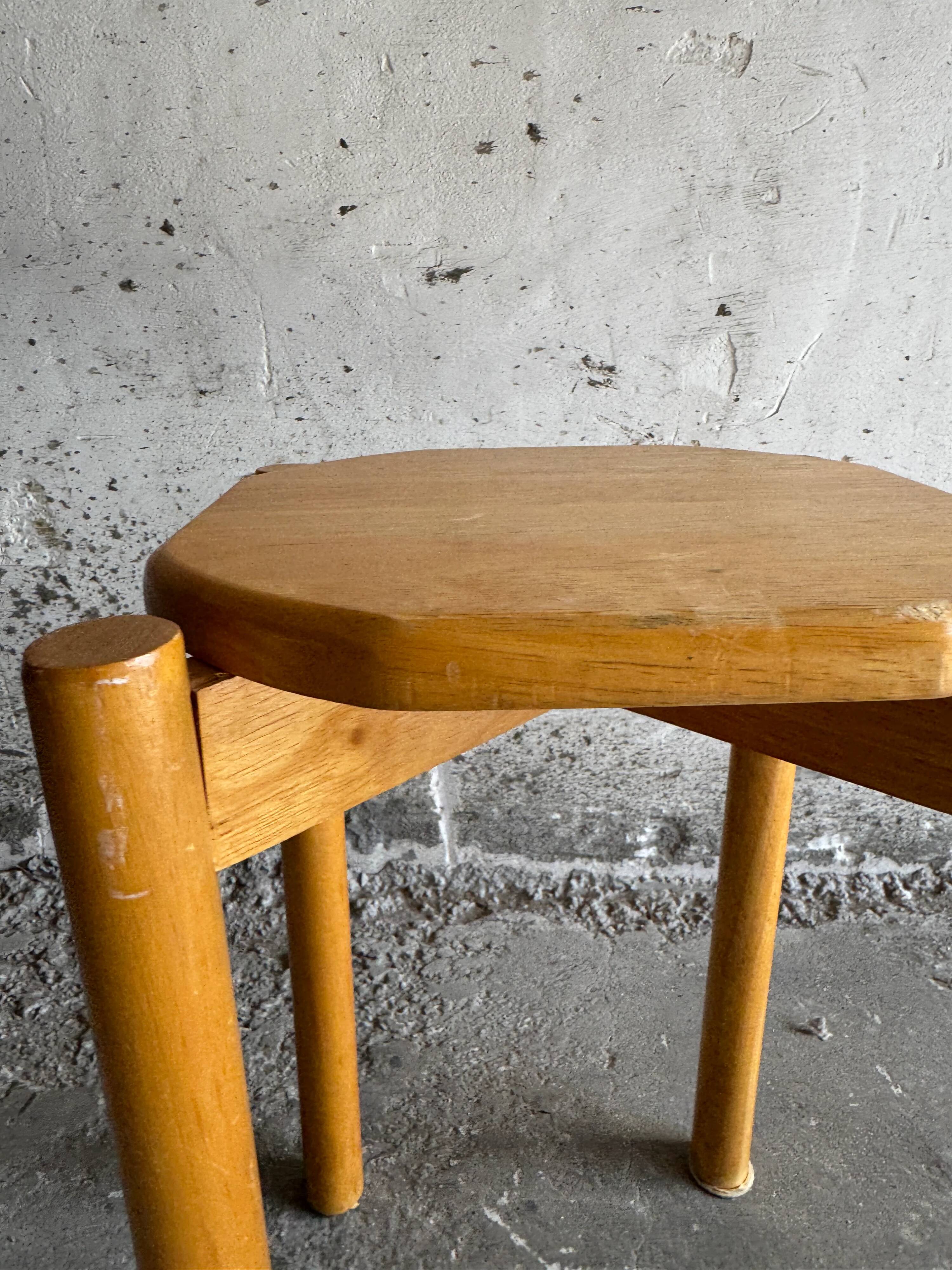 Vintage solid wood stool with an organic-shaped seat.