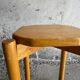 Vintage solid wood stool with an organic-shaped seat.