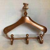 Wall mounted coat rack in the shape of a hanger