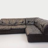 Vintage corner sofa composed of 3 modules in black leather with integrated bed.