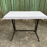 Vintage bistro table with an Art Deco style cast iron base and Formica top.
