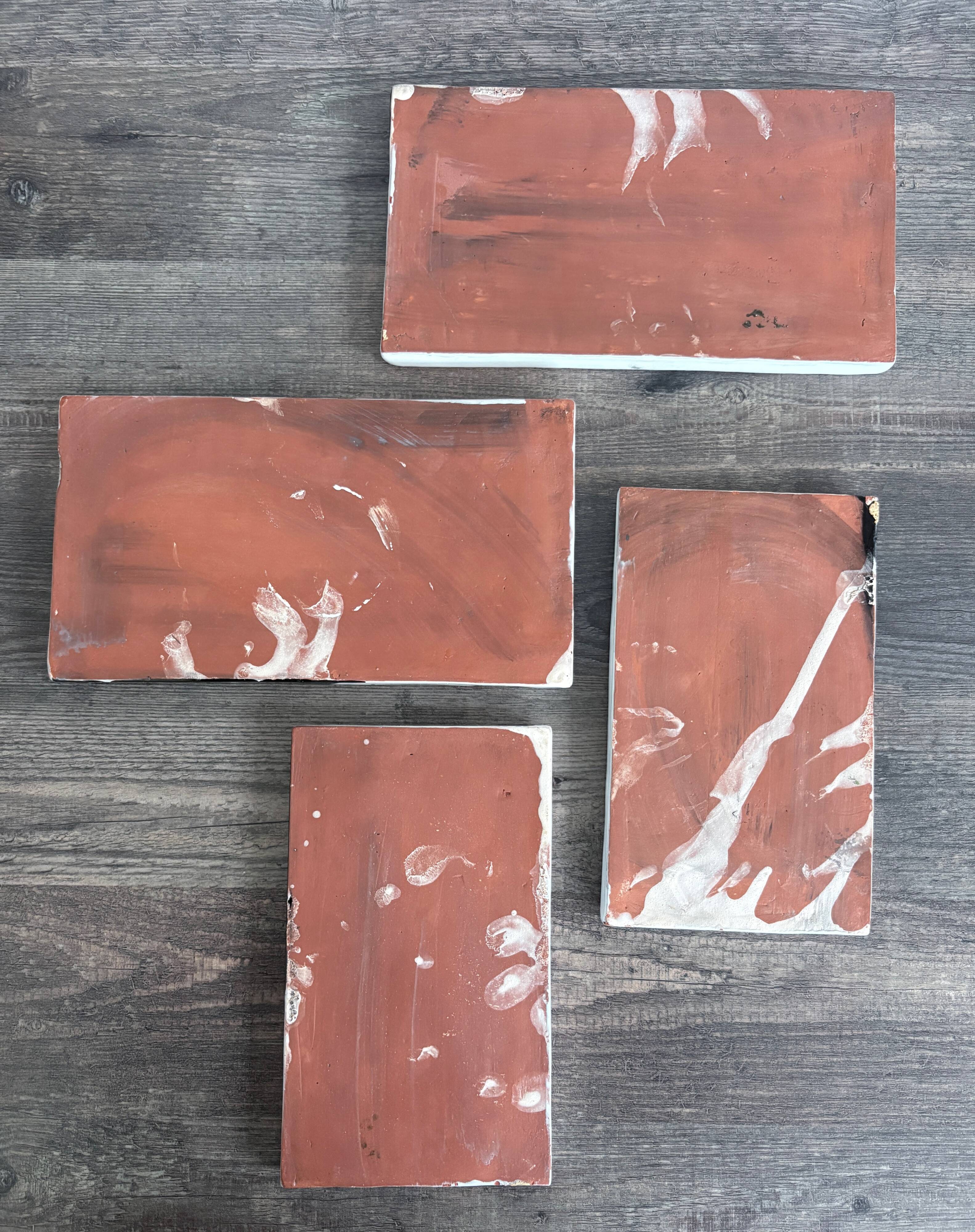 Lot of 4 rectangular glazed terracotta plates.