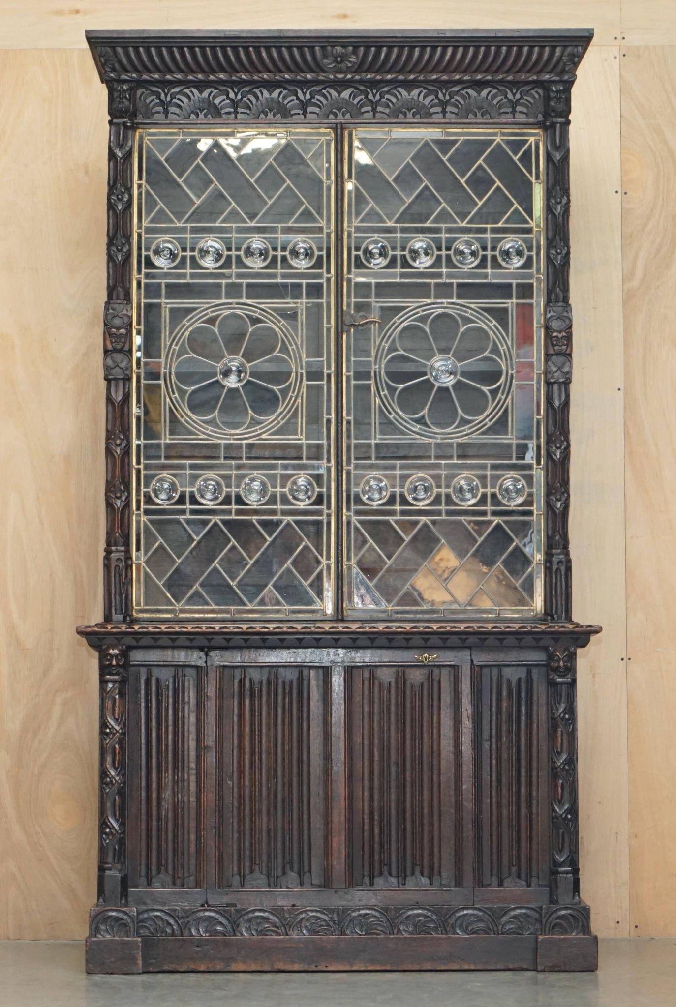 Jacobean hardwood library with carved panels and glass doors.