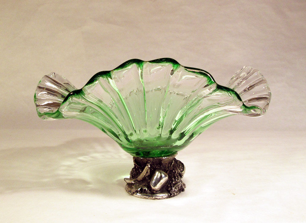 Glass cup on decorated metal stand
