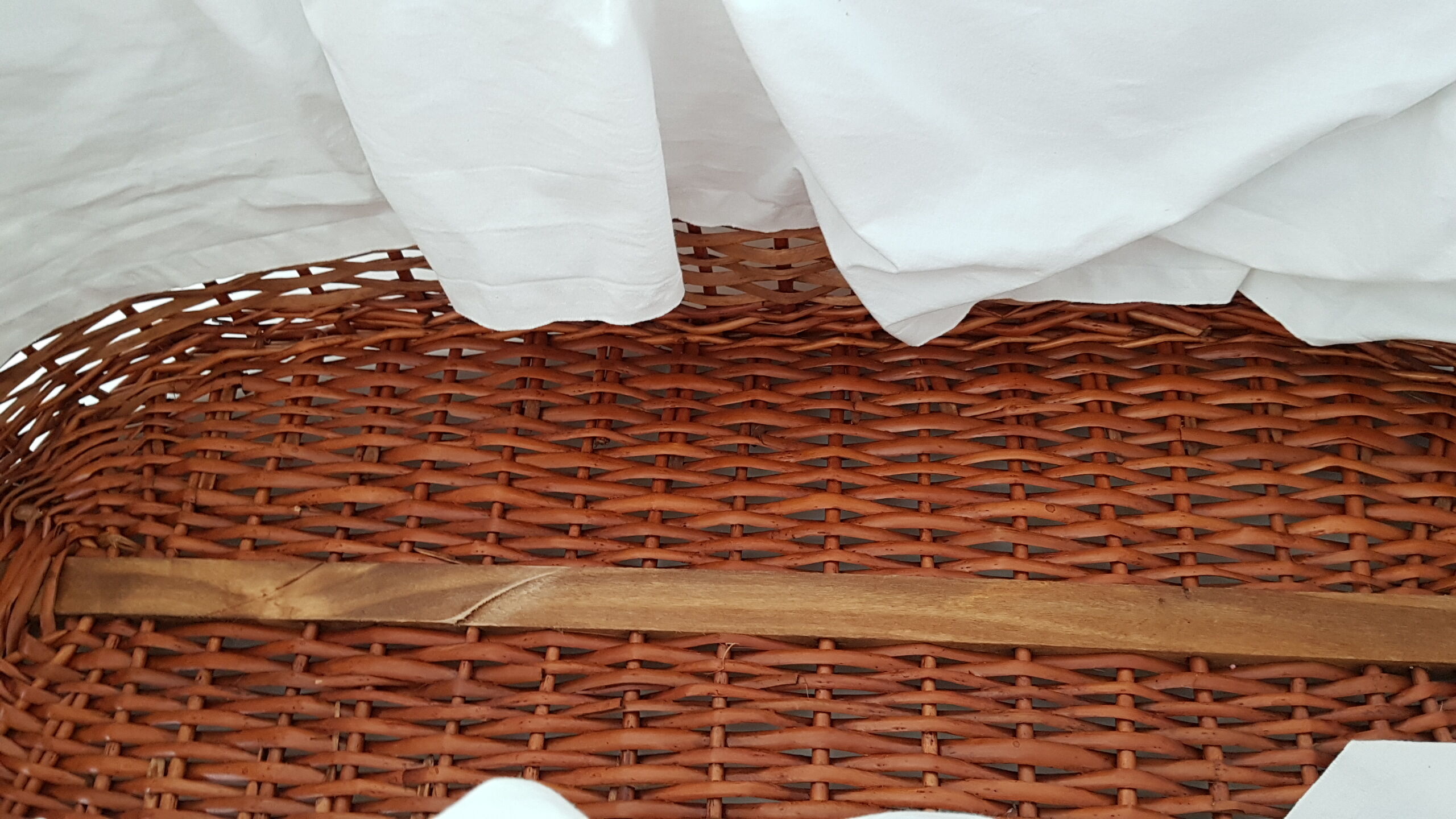 Old rattan bassinet and bedding
