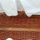 Old rattan bassinet and bedding