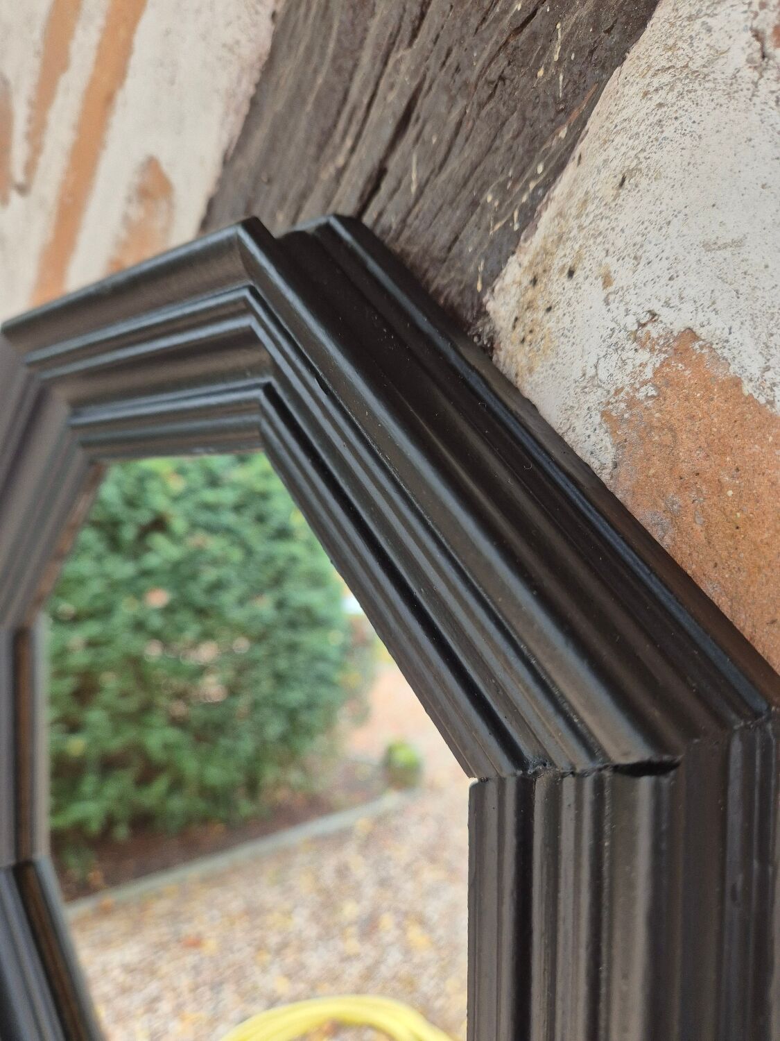 Octagonal black wood mirror