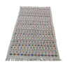White carpet with Berber motifs pink green and blue