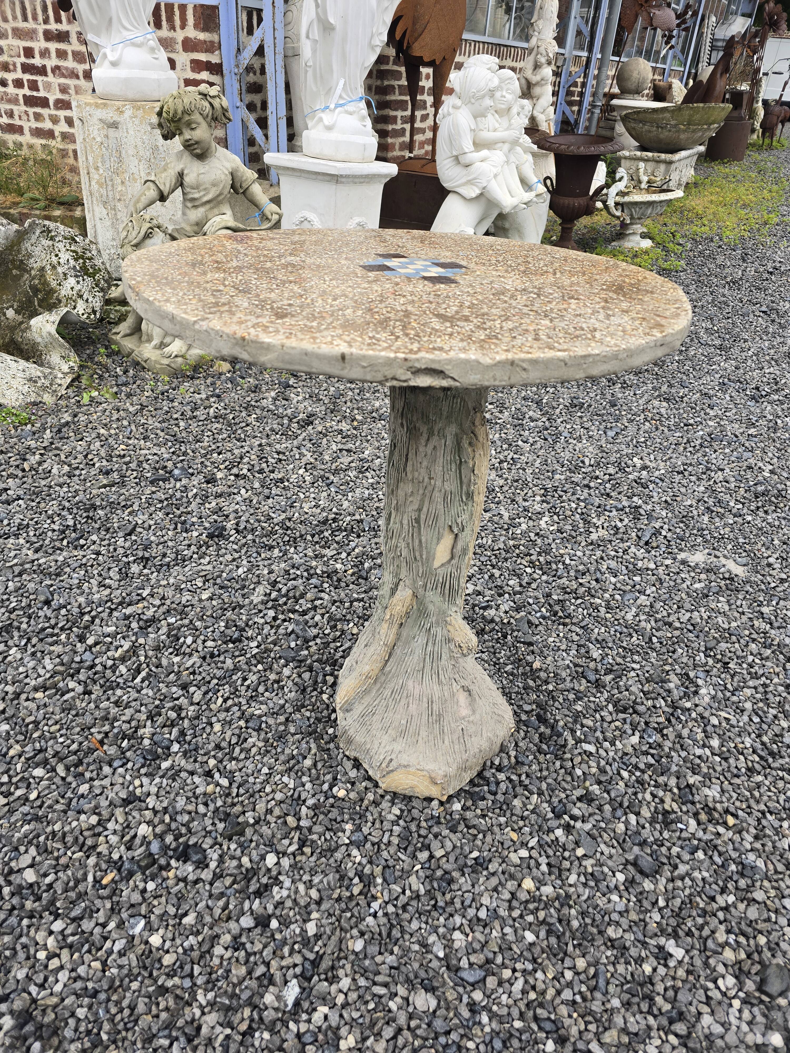 Cement garden table with trunk-shaped foot