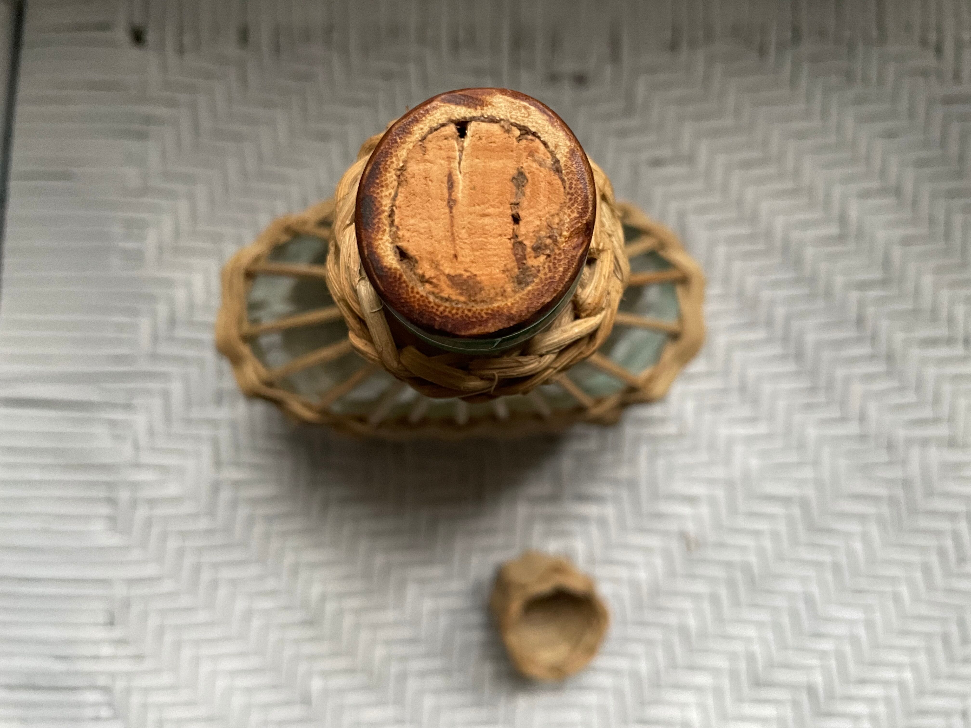 Wicker-sheathed glass bottle