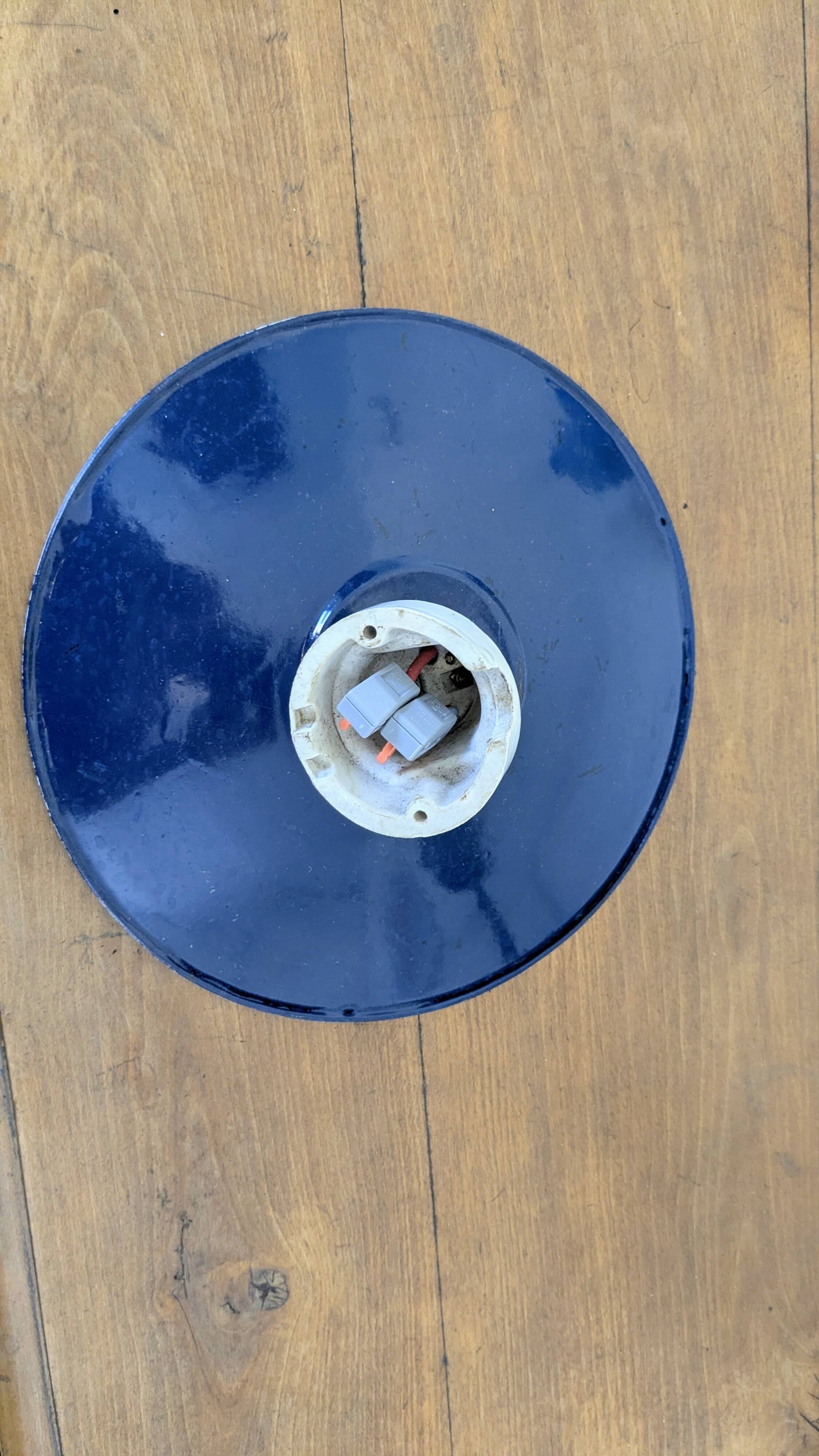 Antique wall light in blue enamel, workshop style.