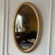 Miroir doré ovale ancien glace biseautée