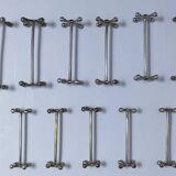 Eleven 70s design metal "crosshair" knife holders