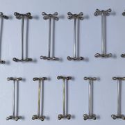 Eleven 70s design metal "crosshair" knife holders