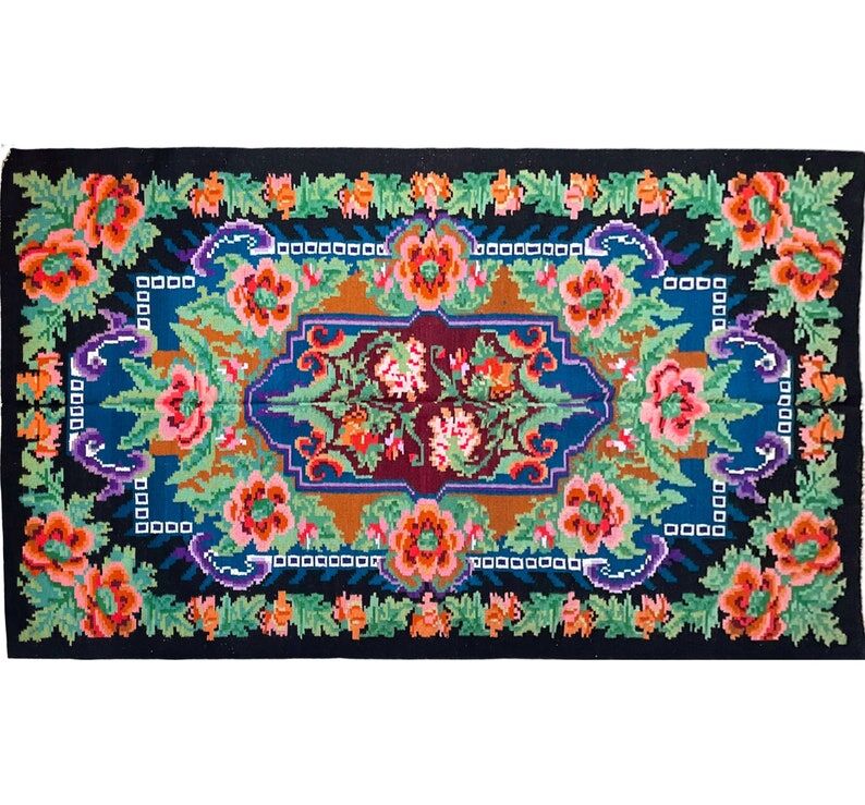 Rug with floral design on a blue background made by hand in Romania