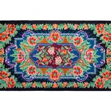 Rug with floral design on a blue background made by hand in Romania