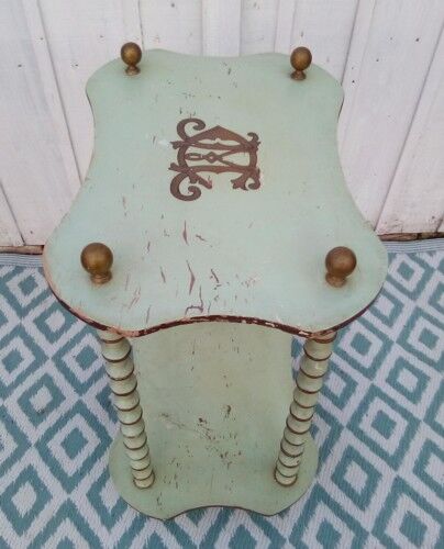 Shelf coils monogrammed patinated wood