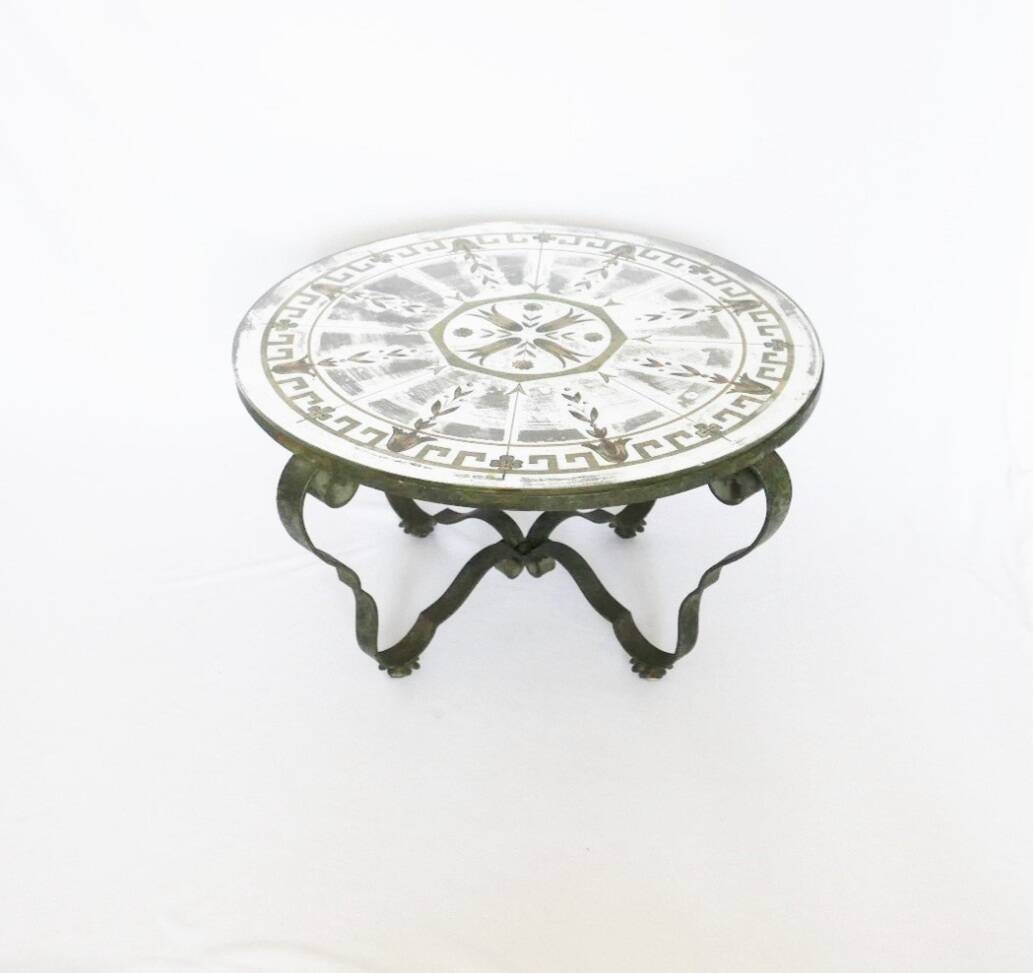 Round table from the 1940s, wrought iron and eglomisé glass.