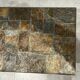 Brutalist-style coffee table made of mixed wrought iron and stone.