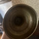 Large antique brass candlestick with floral decoration.