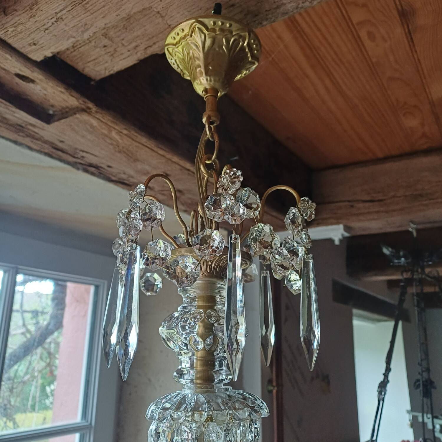Antique chandelier with pendants in bronze and crystal.