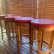Set of 4 bar stools in solid exotic wood and red leather.