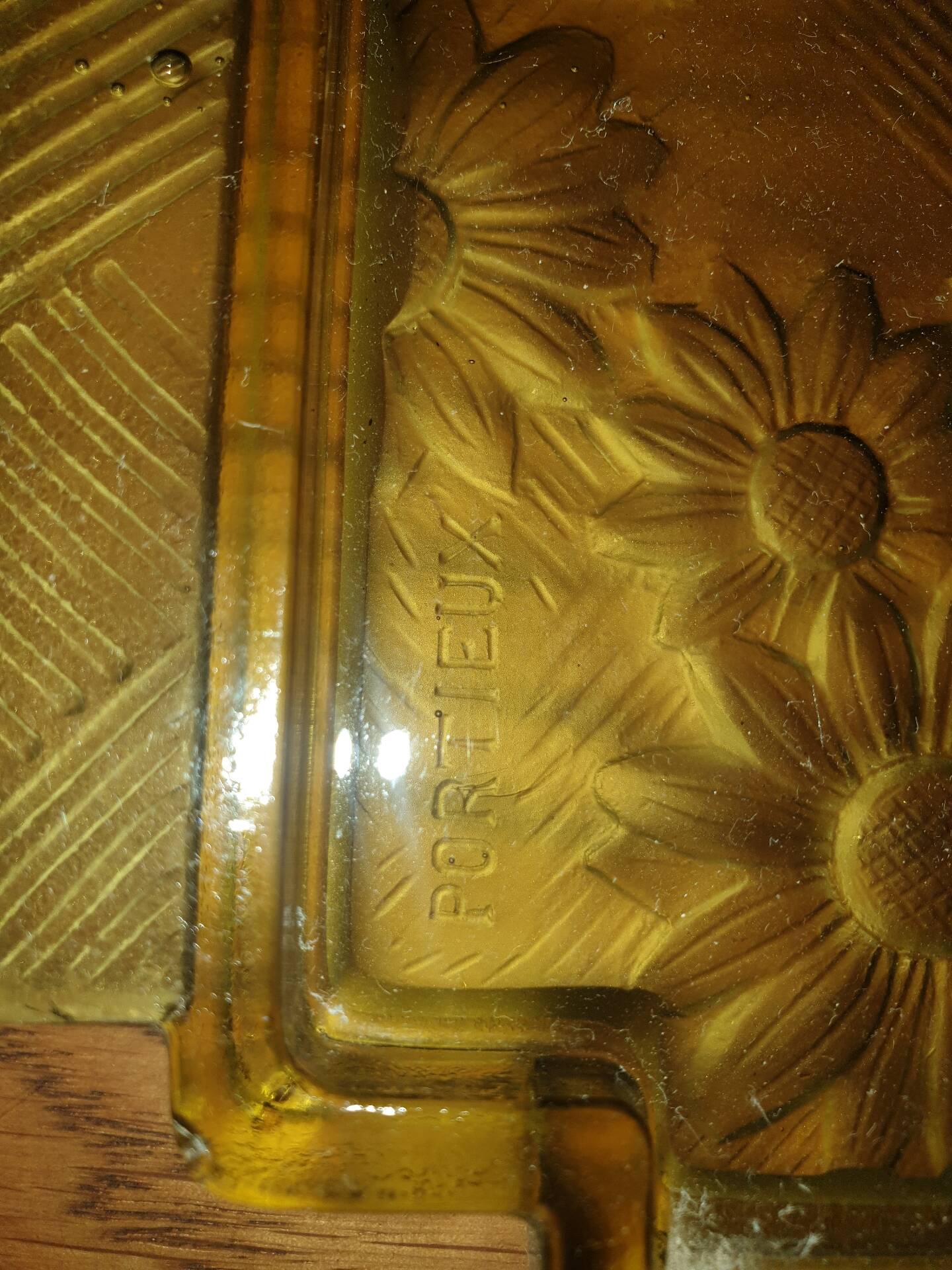 Pressed glass yellow bowl with floral pattern by Portieux.