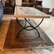 Beige ceramic coffee table with black metal legs.