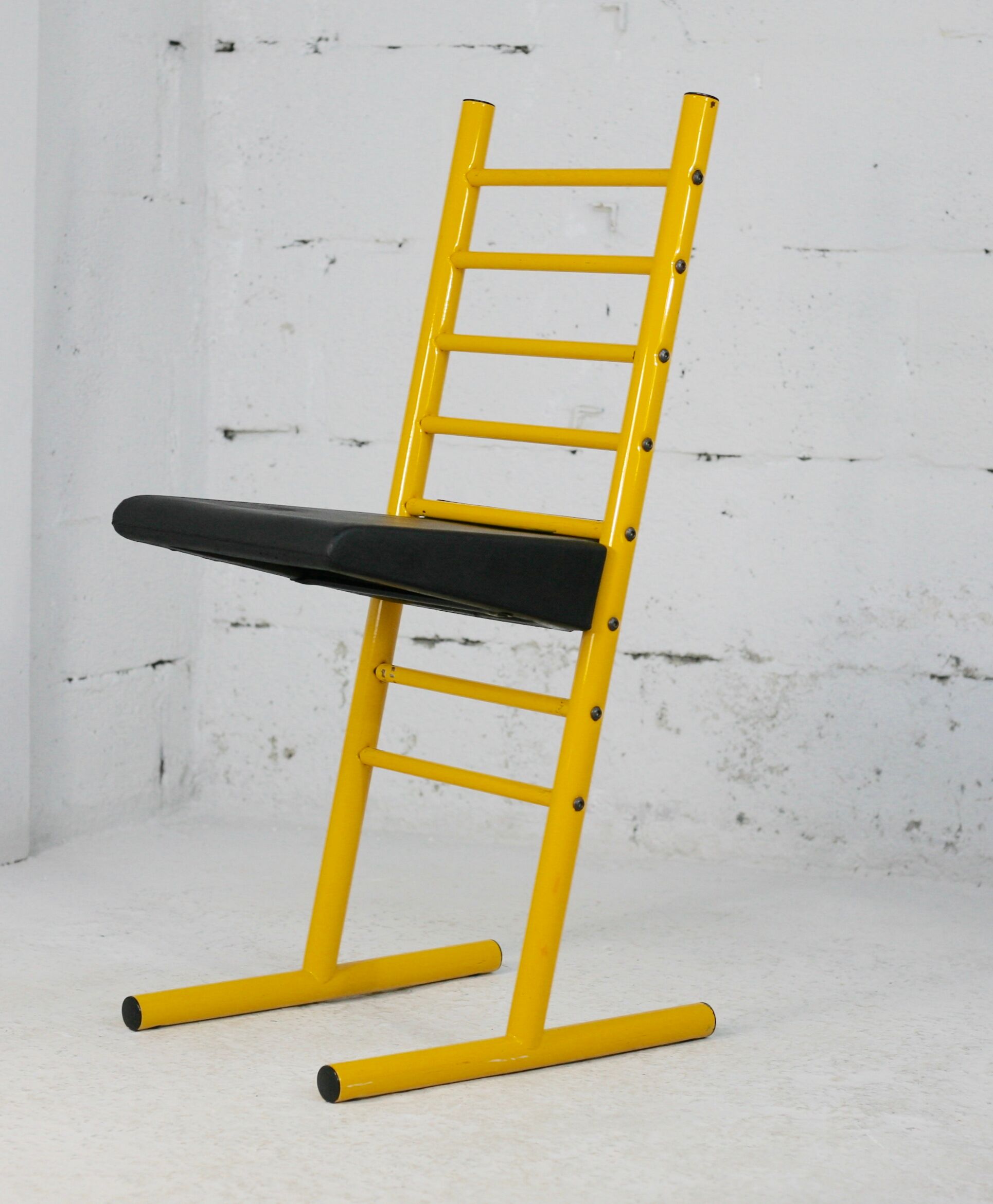 Adjustable seat chair. Circa 1980. Italy. Yellow lacquered steel.