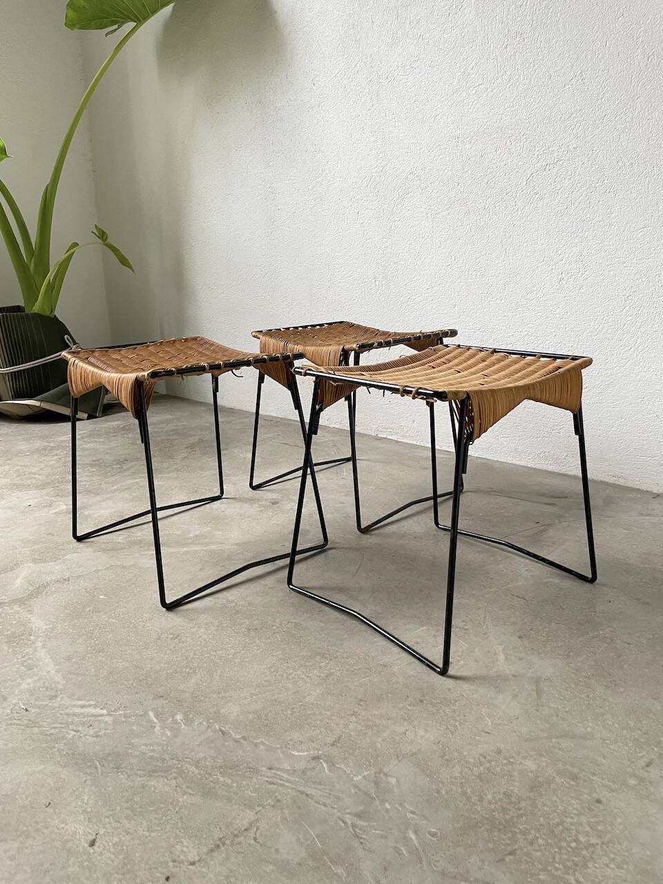 Set of three Raoul Guys wicker and metal stools