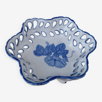 Old bowl with blue floral pattern on a white background