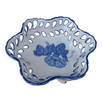 Old bowl with blue floral pattern on a white background