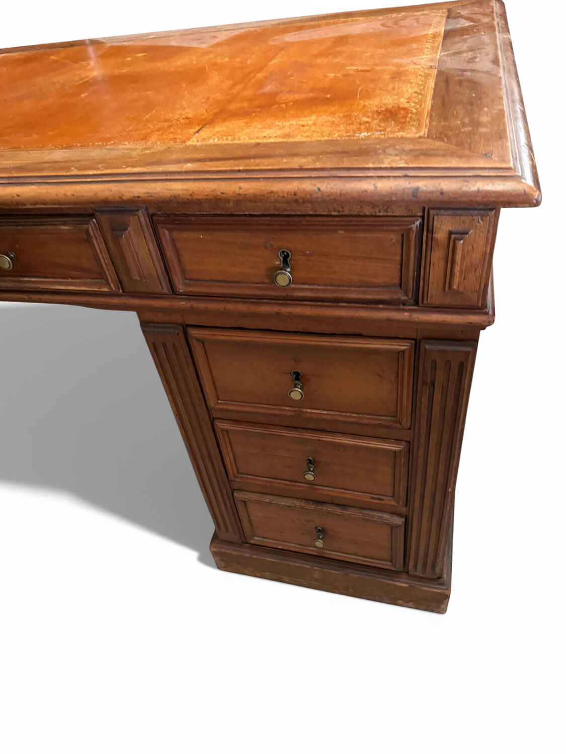 Oak desk with 9 drawers and leather writing pad.