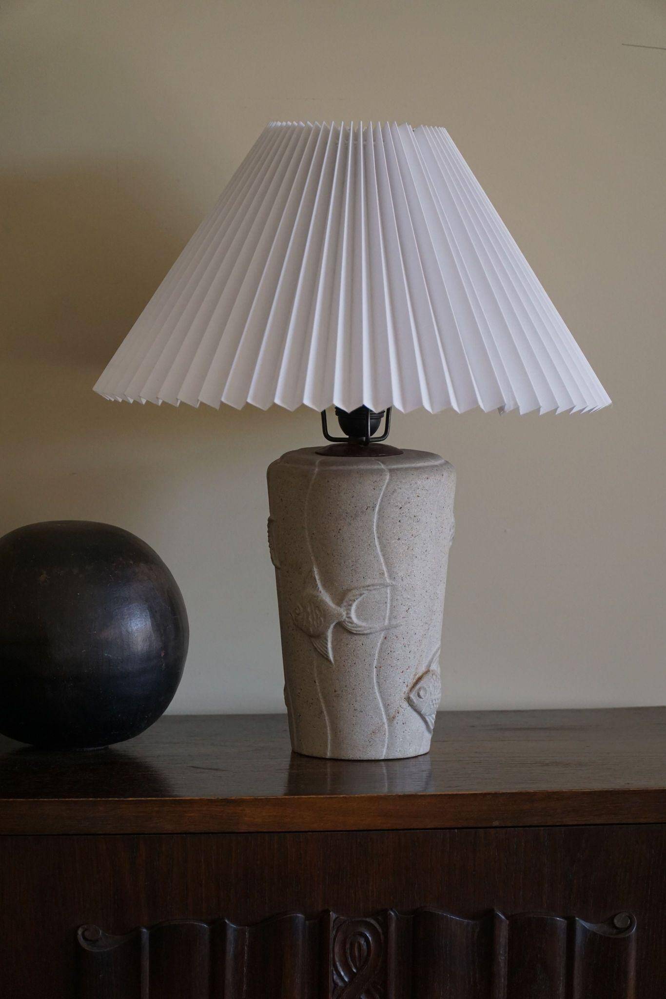 Modern vintage French table lamp, made of stone with fish patterns, 1970s.