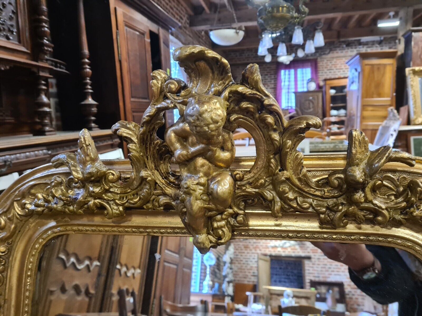 Golden mirror with a flute-playing angel