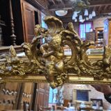 Golden mirror with a flute-playing angel