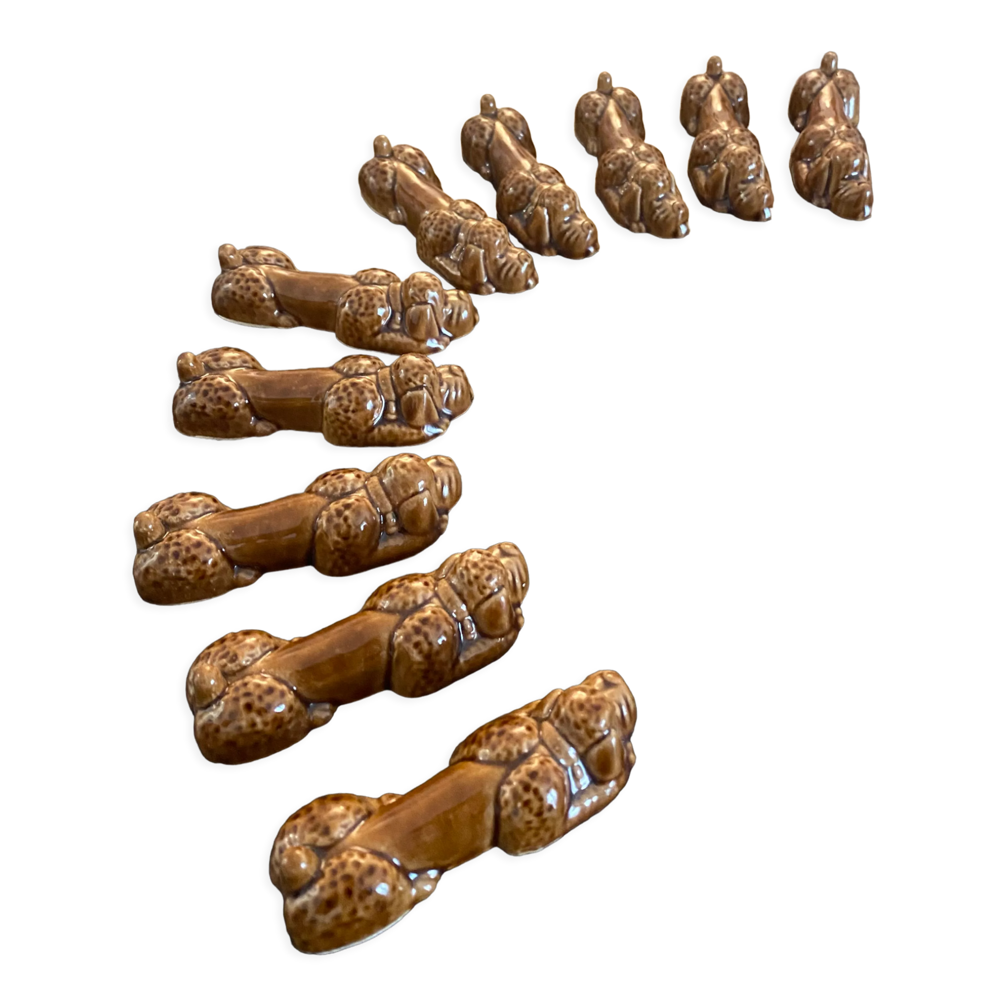 10 ceramic knife holders in the shape of a recumbent poodle