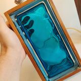 Two Swedish table lamps in solid pressed blue glass and teak wood "frame".