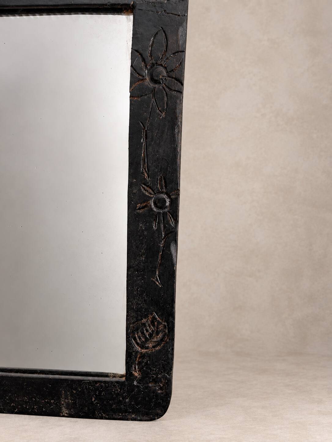Vintage black wall mirror with floral decoration