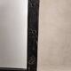 Vintage black wall mirror with floral decoration