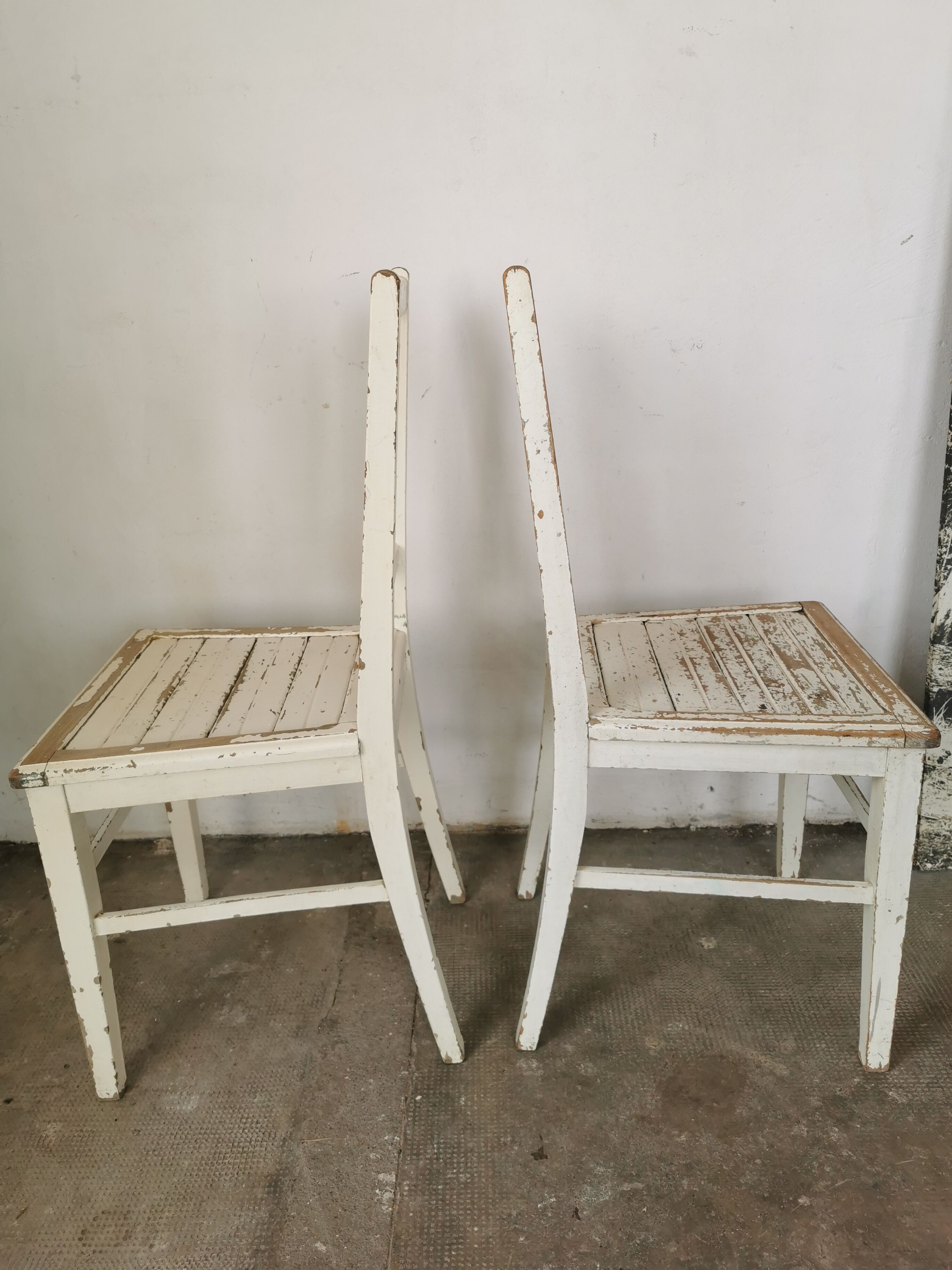 Set of 6 mismatched white chairs