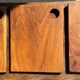 Small rectangular teak monoxyle cutting board with a circular handle.