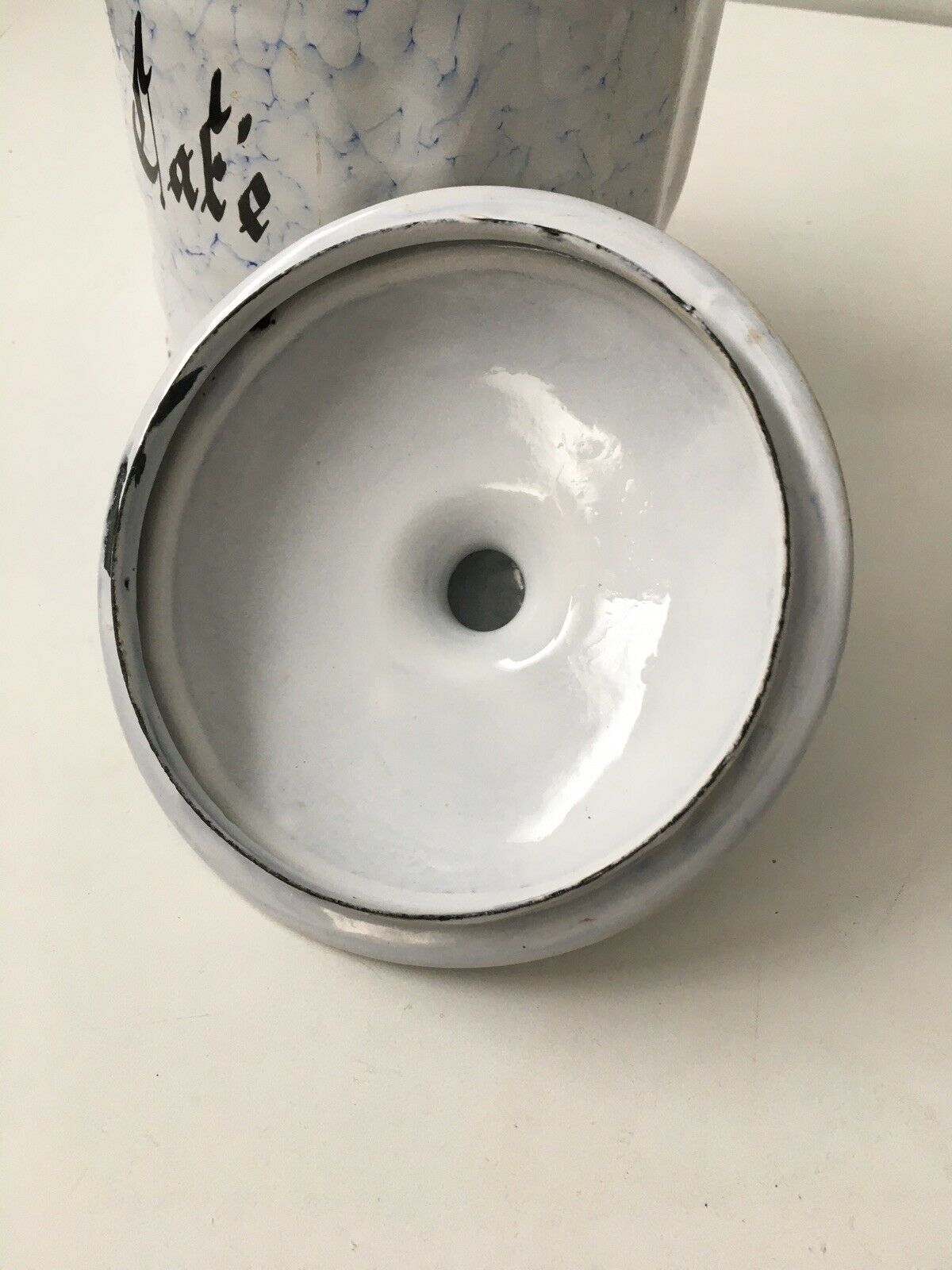 Vintage coffee pot in white enamelled iron and blue retro kitchen decoration