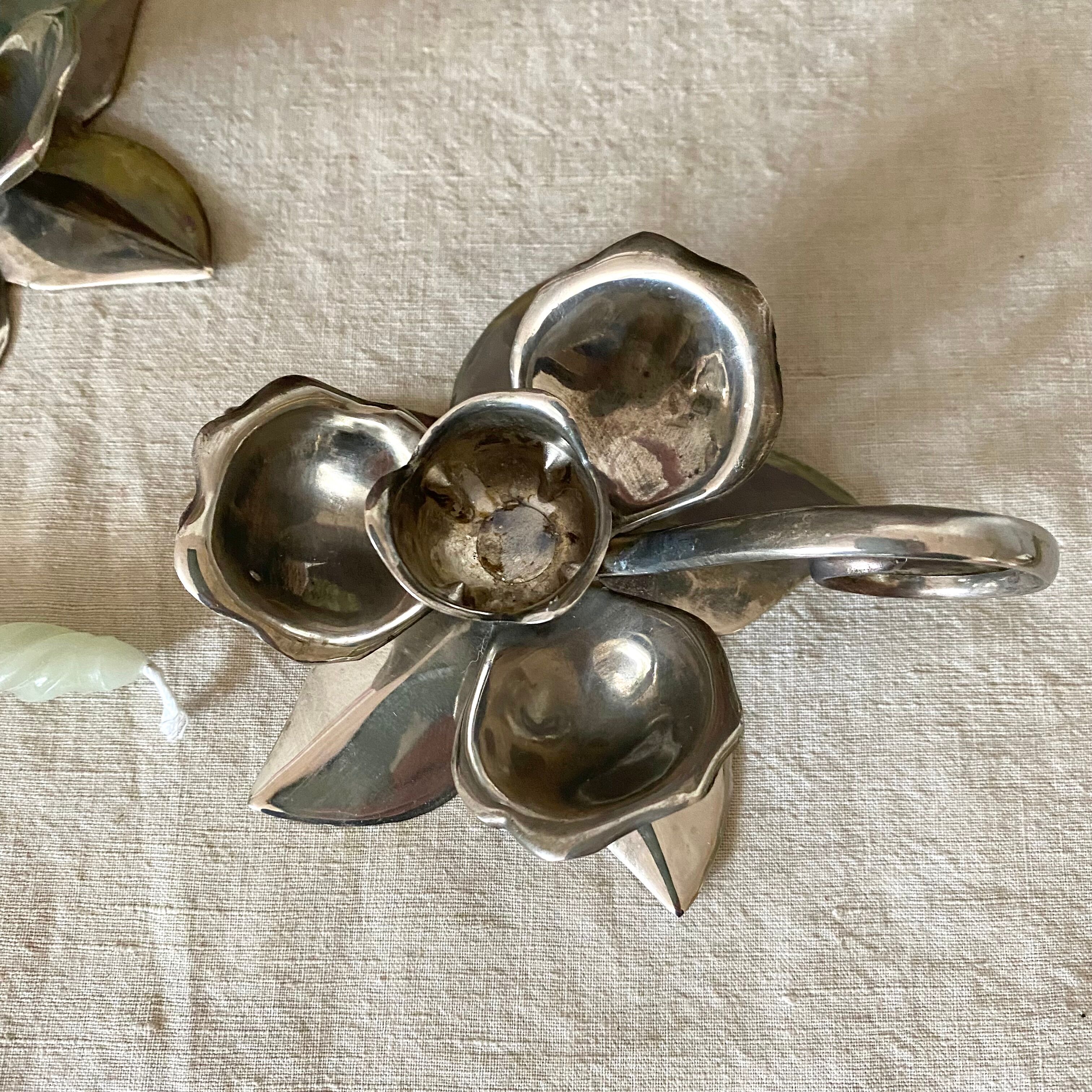 Pair of silver metal flower candle holders
